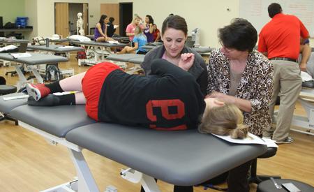 Instructor with a student giving an exam